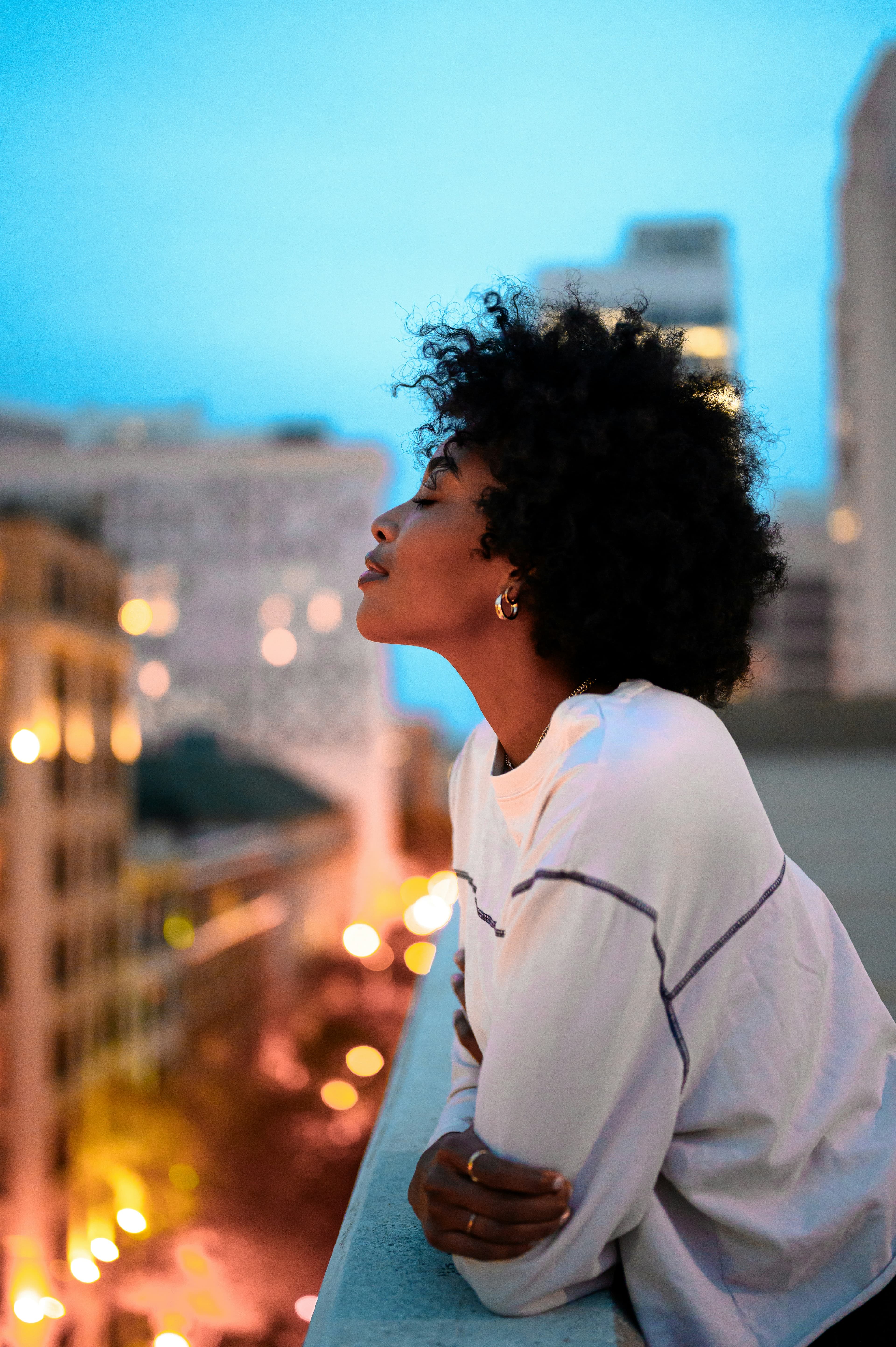 Woman on city rooftop at dusk